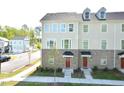 Beautiful three-story townhome featuring a brick and siding exterior with large windows at 1020 Kentlands Dr, Durham, NC 27713