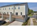 Back of a modern townhome featuring a private deck and a ground level garage at 1020 Kentlands Dr, Durham, NC 27713