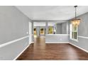 Spacious living room with hardwood floors and a modern light fixture at 105 Ryder Cup Cir, Raleigh, NC 27603