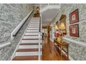Bright foyer with wallpaper, hardwood floors, and a staircase leading to the second floor at 1100 Queensbury Cir, Durham, NC 27713