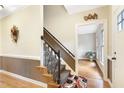 Inviting entryway featuring a staircase with decorative wrought iron details, hardwood flooring, and neutral wall colors at 117 Vicksburg Dr, Cary, NC 27513