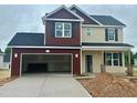 Two-story home with an attached two-car garage and neutral-toned siding, and a dark roof at 120 W Saltgrass Ln, Smithfield, NC 27577