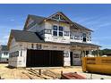 New construction two-story home featuring an attached two-car garage and a modern design at 120 W Saltgrass Ln, Smithfield, NC 27577