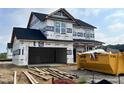 Two-story home under construction featuring a two-car garage and covered entry at 120 W Saltgrass Ln, Smithfield, NC 27577