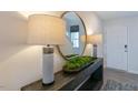 Stylishly decorated entryway with lamps and large mirror to reflect light in the foyer at 125 Holton St, Smithfield, NC 27577