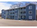 Three-story apartment building with blue siding, multiple balconies, and metal staircase at 1309 Hudson Ave # D9, Durham, NC 27705