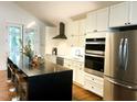 Stylish kitchen featuring stainless steel appliances, white cabinets, and a large kitchen island at 1310 Pender St, Raleigh, NC 27610
