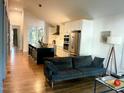 Inviting living room with hardwood floors, a modern kitchen, and an open floor plan at 1310 Pender St, Raleigh, NC 27610