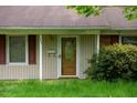 Detailed view of the front door with decorative glass panel and address number at 133 Montree Ln, Graham, NC 27253
