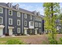 Townhome with gray siding, multiple windows, dormers and light green doors at 139 Callowhill Ln, Durham, NC 27713