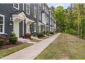 Long view of townhomes with light green doors and sidewalk at 139 Callowhill Ln, Durham, NC 27713