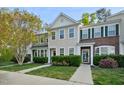 Attractive townhome featuring a manicured front yard and inviting curb appeal at 140 Cedar Elm Rd, Durham, NC 27713