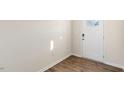 Light and airy entryway with wood-look flooring and a white front door at 144 Global Ave, Fuquay Varina, NC 27526