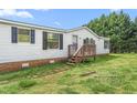 A quaint single-story home with a small porch and brick foundation at 1729 Crawford Rd, Graham, NC 27253