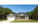 Charming single-Gathering home with an attached garage, well-maintained lawn, and mature trees at 1730 Willie Pace Rd, Burlington, NC 27217