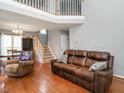 Spacious living room with hardwood floors, high ceilings, and a staircase leading to the second floor at 1850 Crissy Ln, Graham, NC 27253