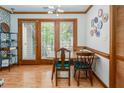 Bright dining area with wood accents, a chandelier and view to an outdoor balcony at 200 W Woodcroft Pkwy # 45C, Durham, NC 27713