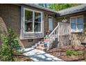 Charming brick townhouse with a white door, steps, and tidy landscaping at 200 W Woodcroft Pkwy # 45C, Durham, NC 27713