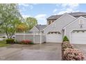 Charming home featuring gray siding, white garage door, and colorful landscaping at 201 Lakewater Dr, Cary, NC 27511