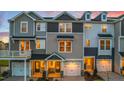 A row of inviting townhomes featuring a combination of stone and siding accents at 219 Pond Vw Ct # 8, Fuquay Varina, NC 27526