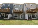 View of the backyard with sliding glass doors, wood balconies, and fenced in area at 2313 Bay Minette Sta # 543, Apex, NC 27502