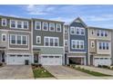 Three townhomes feature unique exterior designs, garage parking, and manicured front lawns for curb appeal at 2313 Bay Minette Sta # 543, Apex, NC 27502