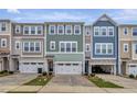 Townhome exterior showcasing colorful facades, attached garages, and landscaped front lawns offering inviting curb appeal at 2313 Bay Minette Sta # 543, Apex, NC 27502