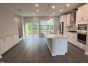 Bright, open kitchen with an island, stainless appliances, and sliding glass doors to the backyard at 2313 Bay Minette Sta # 543, Apex, NC 27502