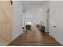 Open living space showcasing wood floors, modern lighting, and a seamless flow to the kitchen at 251 Sequoia Dr, Louisburg, NC 27549