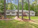 Charming ranch-style home with a stone pathway leading to the front door and lush landscaping at 2805 Chelsea Cir, Durham, NC 27707