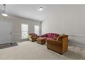 Inviting living room boasting neutral walls and carpeting, with ample natural light at 292 Joshua Glen Ln, Cary, NC 27519