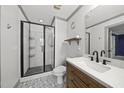 Modern bathroom featuring a glass-enclosed shower, sleek vanity, patterned floor tiles, and contemporary fixtures at 301 Marsh Landing Dr, Holly Springs, NC 27540