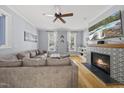 Inviting living room with a cozy fireplace, neutral color palette, plush seating, and lots of natural light at 301 Marsh Landing Dr, Holly Springs, NC 27540