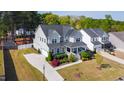 Aerial view of a two-story home with a well-manicured lawn, an attached garage, and a spacious driveway at 3037 Freeman Farm Way, Rolesville, NC 27571