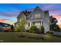 Charming two-story home with well-manicured lawn and mature trees creating curb appeal at 3037 Freeman Farm Way, Rolesville, NC 27571