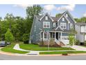 Charming two-story home with manicured lawn, corner lot, and an inviting front porch at 33 Highpointe Dr, Pittsboro, NC 27312