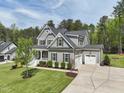 Gorgeous two-story house featuring pristine landscaping, a spacious driveway, and an attached garage at 3545 Donlin Dr, Wake Forest, NC 27587