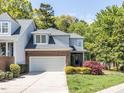 Beautiful two-story townhouse with a two-car garage, brick accents, landscaped yard, and serene surroundings at 3608 Burwell Rollins Cir, Raleigh, NC 27612