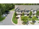 Well-maintained two-story townhomes with attached garages, mature trees, and a green, landscaped lawn at 3667 Durwood Ln, Raleigh, NC 27604
