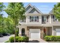 Charming two-story townhome with stone accents, attached garage, well-maintained landscaping, and inviting curb appeal at 3667 Durwood Ln, Raleigh, NC 27604