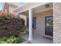Inviting front porch with brick accents, columns, and a cozy swing for relaxation at 3811 Yates Mill Trail, Raleigh, NC 27606