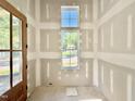 Bright entry way featuring light-filled windows and a wooden door ready to welcome you home at 3817 Coach Lantern Ave, Wake Forest, NC 27587