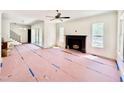 Spacious living room with fireplace, large windows, and natural light, awaiting personalization at 3817 Coach Lantern Ave, Wake Forest, NC 27587