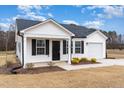 Inviting single-story home with white siding, black shutters, and a well-manicured lawn at 385 Dasu Dr, Clayton, NC 27520
