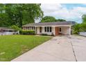 Attractive single-story home with a well-kept lawn, covered carport, and classic brick and siding exterior at 3913 Vesta Dr, Raleigh, NC 27603