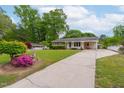 Lovely home with long driveway, well-maintained lawn, and a charming garden featuring vibrant azaleas at 3913 Vesta Dr, Raleigh, NC 27603