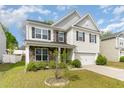 Two-story home featuring stone accents, gray and white siding and shutters, and a two-car garage at 3917 White Kestrel Dr, Raleigh, NC 27616