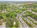 An aerial view showcasing the neighborhood, nearby Downtown Cary Park, and lush green surroundings at 408 Madison Ave, Cary, NC 27513
