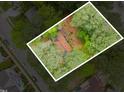 An aerial view of the property, bordered by mature trees and green space offering a private, secluded setting at 408 Madison Ave, Cary, NC 27513