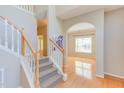 Staircase leading to the upper level, showcasing hardwood floors and an arched doorway at 413 Palafox Dr, Chapel Hill, NC 27516
